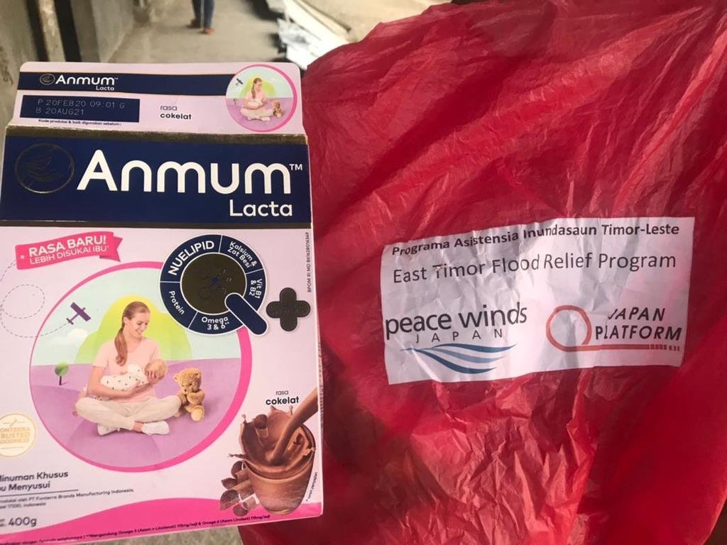 Anmum Lacta beside a bag labelled East Timor Flood Relief Program